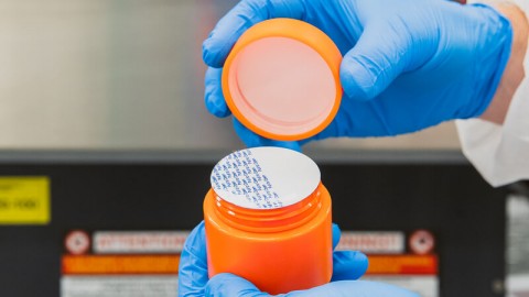 Container filled with induction sealed cap