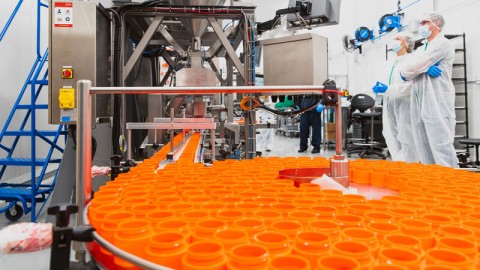 Container filling system with rotary table and labeling for cannabis
